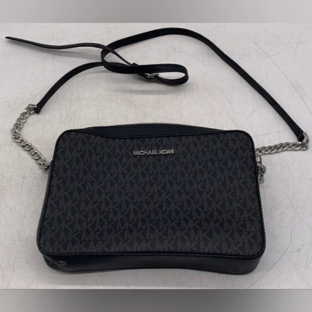 Michael Kors Black Crossbody Bag with Signature MK Design.